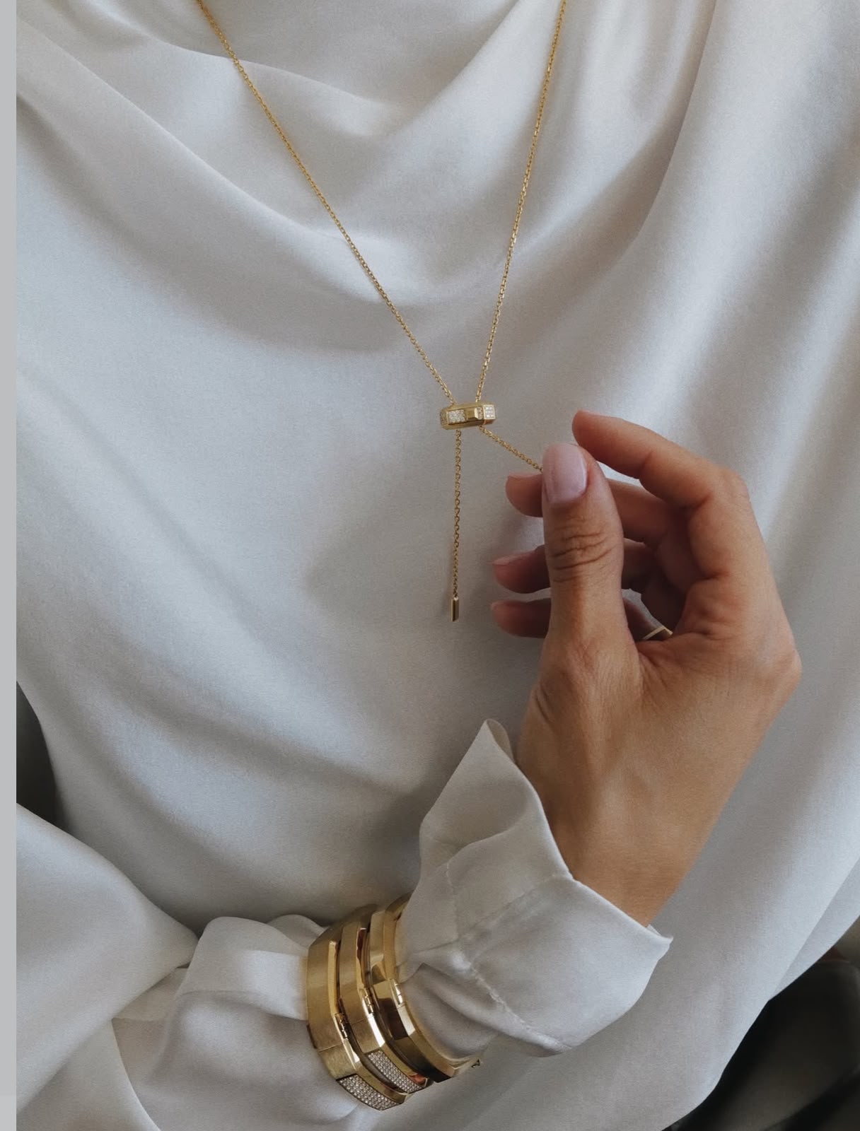 Gold jewelry and white blouse